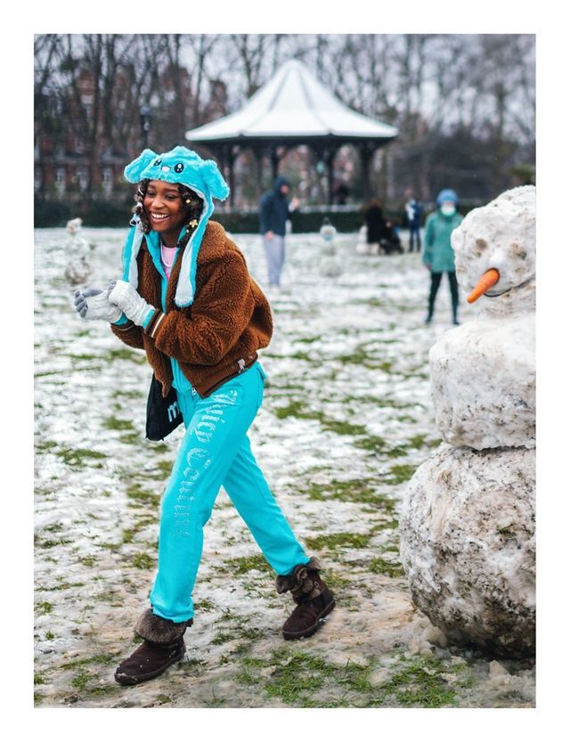 A person in turquoise trousers in the snow