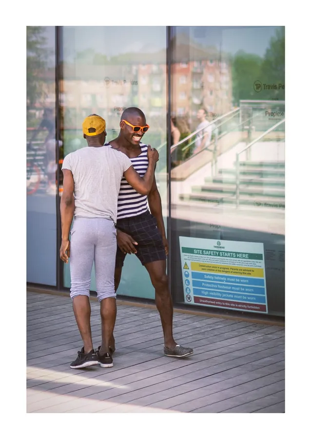 Two people standing outside a shop