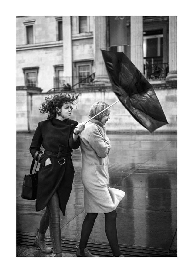 Two people sharing an umbrella in the city